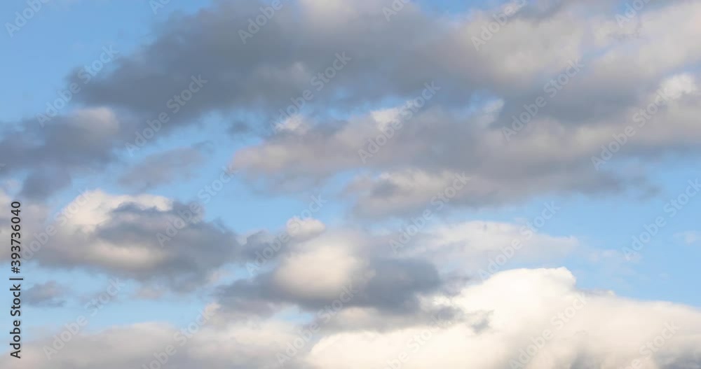 Wall mural white clouds of different shapes and sizes fly in time lapse fashion over a vivid blue sky on a part