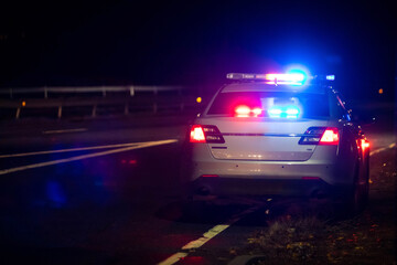 Obraz na płótnie Canvas Police emergency flash lights at night from the back