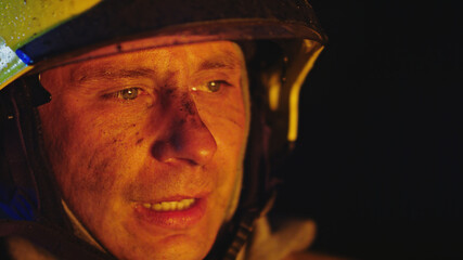 Portrait shot of a fireman in helmet. . High quality photo