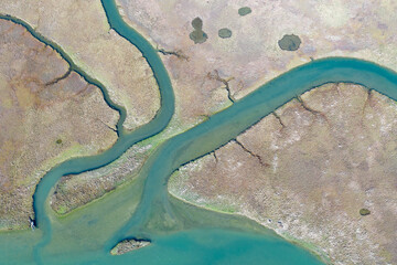 Narrow channels meander through a beautiful estuary in Central California. Estuaries form when freshwater runoff meets and mixes with saltwater from the ocean. Lots of wildlife rely on estuaries.