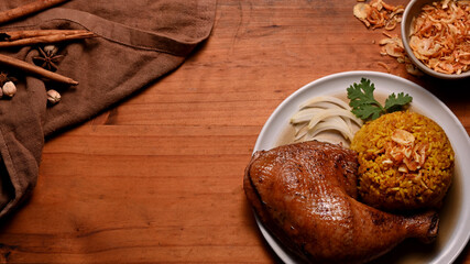 Delicious chicken biryani with rice marinated in spices on ceramic plate