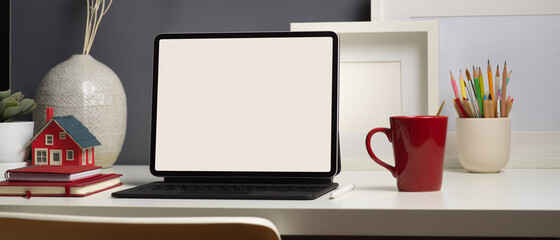 Workspace with digital tablet , supplies and decorations in home office room