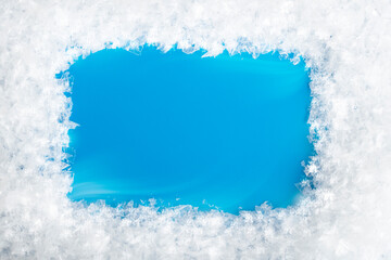 snow frame on blue background with blank space for text, copy space. Template for winter design