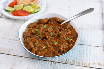 Kerala beef curry , Goan style beef vindaloo , Indian food Lamb or beef curry . spicy Beef curry gravy popular in Kerala Sri Lankan Goa side dish for Appam, Parotta porotta roti bread in India.