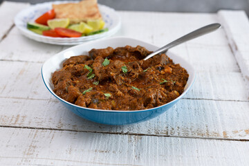 Spicy beef curry , Goan style beef vindaloo , Traditional Indian Lamb or beef curry . spicy Beef curry gravy popular in Kerala Sri Lankan Goa side dish for Appam, Parotta porotta roti bread in India.