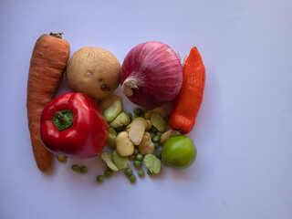 Group of vegetables on a white table.