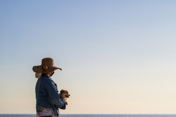  woman with hat and wearing face  travel concept new normal on beach