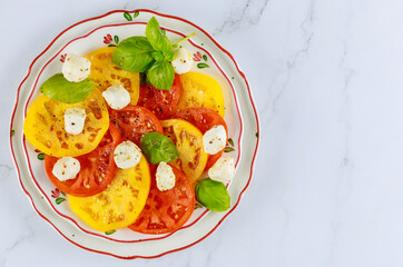Basil, mozzarella and tomato in plate on white background.