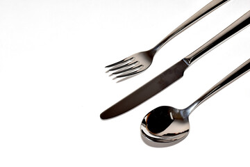 Cutlery Silverware Set with Spoons, forks, steak knives isolated on white background with copy space. Selective Focus.