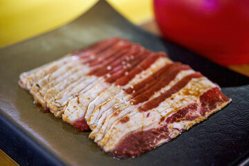 Close-up of a dish of thin-cut beef uncooked meat