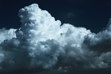 Fototapeta premium Close-up of white fluffy clouds at night in the moonlight.