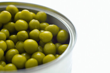 Closeup of canned peas in a tin can isolated on a white background.
