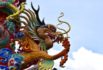 Fototapeta premium Colorful Dragon Decoration with blue sky background at Chinese Temple, Thailand.