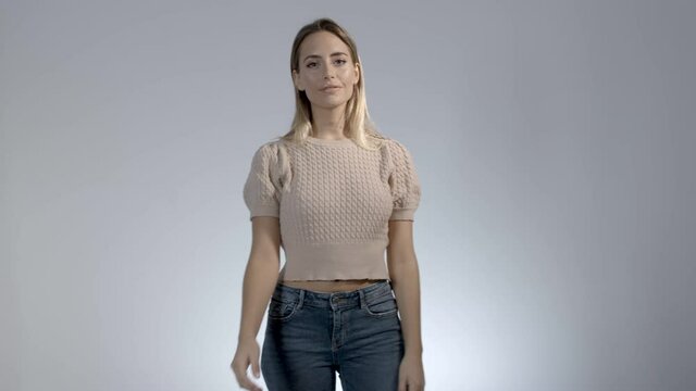 Young woman clicking fingers and swapping outfits