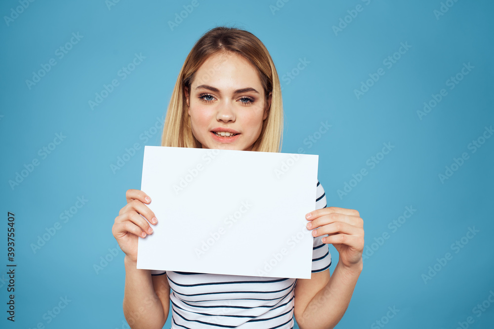 Poster Woman holding sheet of paper striped T-shirt Copy Space cropped view blue background