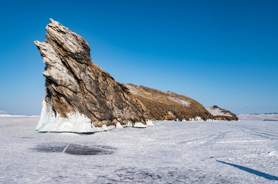 Spectacular landscape of the Dragon tail rock located at Ogoy island in frozen lake Baikal in winter season. Lake Baikal is the world's deepest lake located in southern Siberia, Russia.