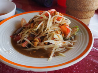 closeup thai spicy papaya salad dish on table