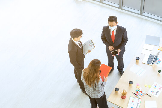 Businessmen, secretaries and executives meeting  and wareing mask to prevention coronavirus or covid-19. Business strategy planning for the next year concept. Top view.