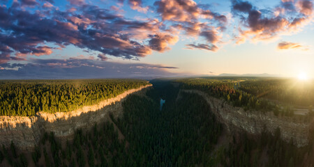 Beautiful Panoramic View of Canadian Nature and a Rocky Canyon, surrounded by cliffs, trees. Aerial...