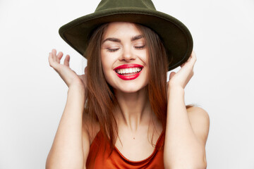 Woman with a hat Keeps hands near the face smile closed eyes on her head model