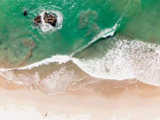 Tuinposter Waves crashing on beach from above © Jayce