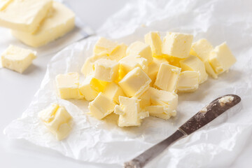Cubes of fresh butter on white background