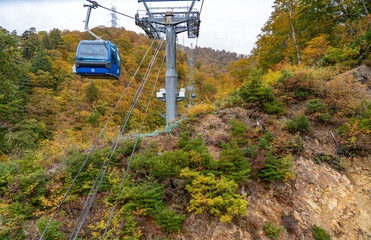 View of mountains and valleys from the Dragondola (Naeba-Tashiro Gondola) in autumn foliage season....