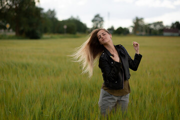 Beautiful girl with long hair in a field