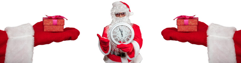 Santa Claus holding a white clock which shows five minutes to midnight. Two hands with gifts on them extended to him. New year's eve concept. Isolated on white background