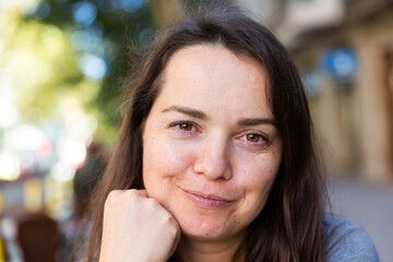 Closeup face of romantic girl walking through city streets