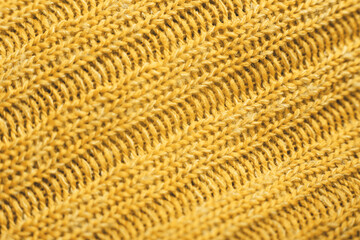 Close up of yellow knitted textured background. Trendy color.