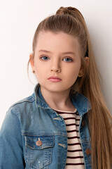 close-up portrait of a beautiful girl in a denim jacket on a white background