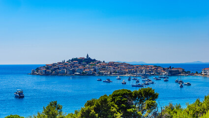 Primosten is a resort town on an island connected to the mainland by a bridge.