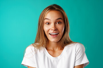 Shocked and amazed young blonde woman close up portrait.