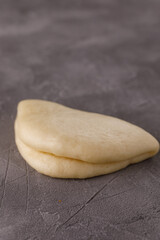 Steamed wheat bun dressed with designer sauce. Vietnamese cuisine concept. Still life. Close-up.