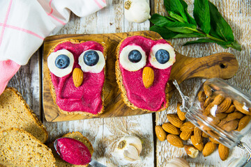 Fun food for kids - cute little owls shaped sandwiches. Spread of beets, chickpeas, almonds and...