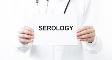 Doctor holding a card with text SEROLOGY, medical concept