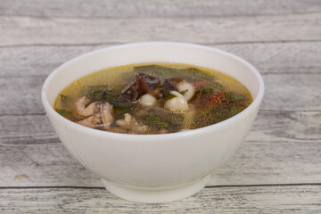 Thai style soup with meat and mushrooms