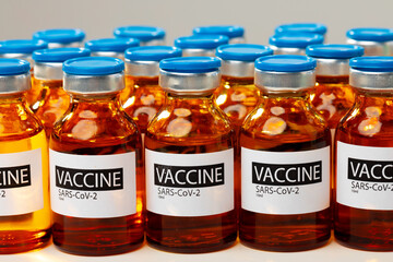 Sars-cov-2 vaccine vial bottles on white table
