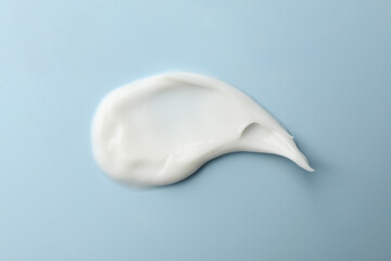 Cosmetic cream on blue background, close up