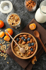 Concept of tasty breakfast with granola on black smokey background