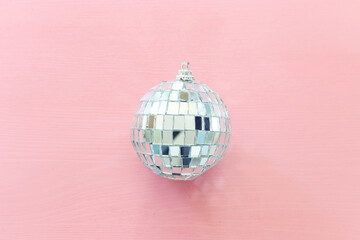 Small Christmas disco ball on pink background