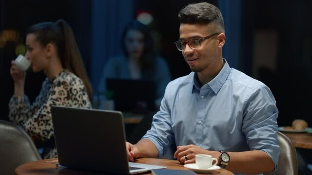 Businessman making video conference online with client at remote workplace