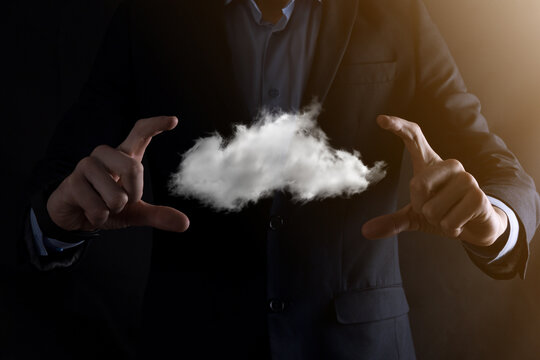 Businessman man hand holding cloud.Cloud computing concept, close up of young business man with cloud over his hand.The concept of cloud service. © Ivan
