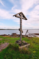 Close-up of a wooden Orthodox cross on a summer evening against the White sea, Russia.