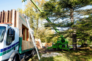 truck transporting parts of a wooden house