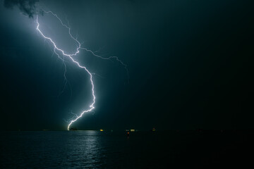 Lightning bolt strikes in the water of the sea