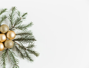 Fototapeta na wymiar Christmas flat lay with fir pine branches and golden Christmas balls on the white background. Minimalist style. Copy space
