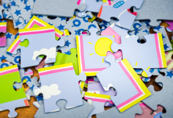 Close-up of colorful puzzles for children of different sizes lying on the floor - 393797460