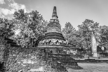 Landmark of old chedi made of ancient bricks in the Kamphaeng Phet Historical Park, Thailand. Black and white